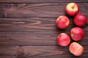 Fresh red apples on wooden background
