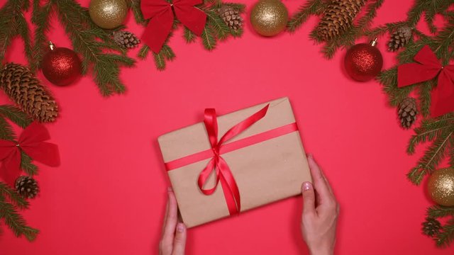 Hands placing Christmas gift box