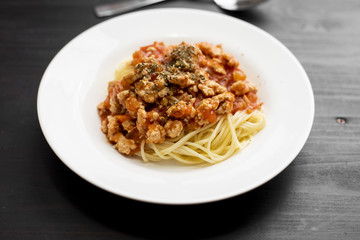 Spaghetti on black wooden background