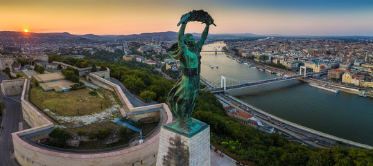 Budapest, Hungary - Panoramic view of the Hungarian Statue of Liberty at sunrise with Elisabeth Bridge and Szechenyi Chain Bridge and skyline of Budapest at background