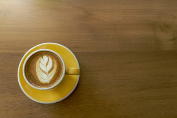 Coffee cup and beans on wooden table. Top view with copyspace for your text