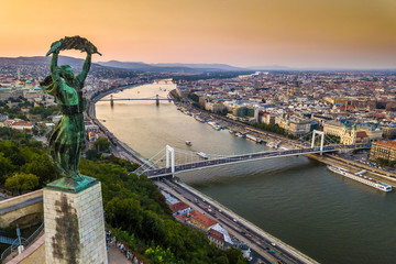 Budapest, Hungary - The Hungarian Statue of Liberty at sunrise with Elisabeth Bridge and Szechenyi Chain Bridge and skyline of Budapest at background © zgphotography