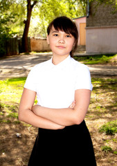 Fototapeta premium Portrait of a teenage girl, in strict clothing. The girl in the park