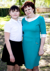 Obraz premium A young, beautiful woman is hugging a teenage girl. Mom and daughter.