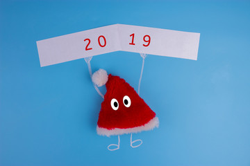 Red and white santa hat character shot on a blue background
