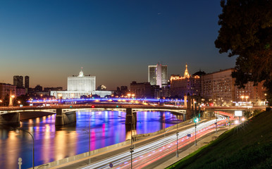 Fototapeta na wymiar House of the government of the Russian Federation, beautiful Moscow river, night road and water traffic along the river and the embankment