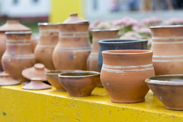 Several ancient clay pots of different shapes and sizes, close-up