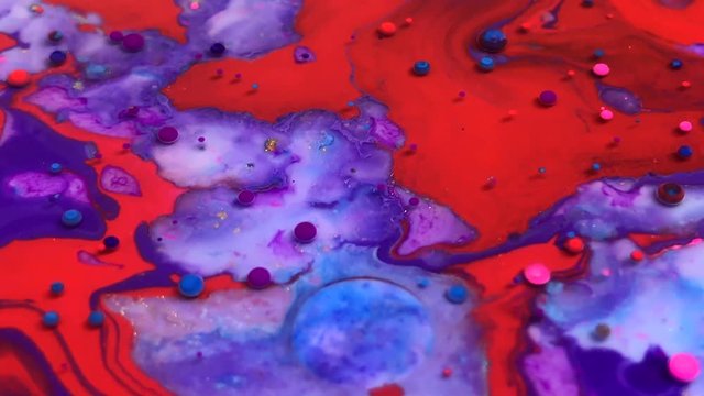 Abstract colorful bubbles marble background with milk oil and soap. Colored inks react to a drop of liquid soap in the oil.