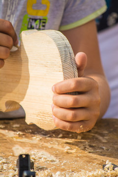 Children learn to make custom violin and other musical instruments in outdoor fablab classes. Joiner's training on makerfaire.