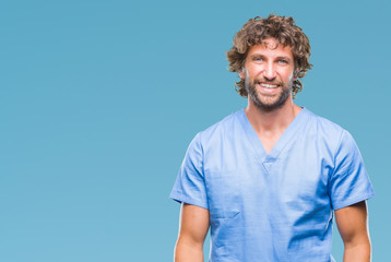 Handsome hispanic surgeon doctor man over isolated background with a happy and cool smile on face....