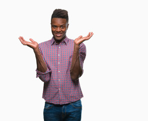 Young african american man over isolated background clueless and confused expression with arms and...