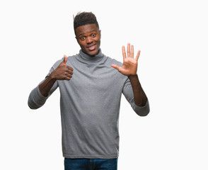 Young african american man over isolated background showing and pointing up with fingers number six while smiling confident and happy.