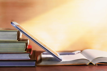 Open textbook and notepad on the table.
