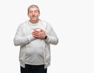 Handsome senior man wearing sport clothes over isolated background smiling with hands on chest with closed eyes and grateful gesture on face. Health concept.