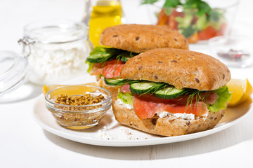 sandwich with salted fish, fresh vegetebles and cream cheese on the plate