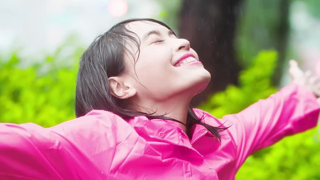 woman wear raincoat enjoy rain