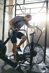 Fototapeta na wymiar Cardio Workout. Sport Man Training On Bicycle, Cycling Exercise