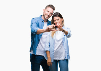 Young couple in love over isolated background smiling in love showing heart symbol and shape with hands. Romantic concept.