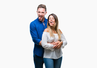 Young couple in love over isolated background sticking tongue out happy with funny expression. Emotion concept.