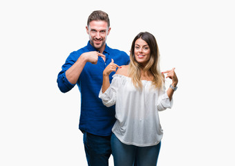 Young couple in love over isolated background looking confident with smile on face, pointing oneself with fingers proud and happy.