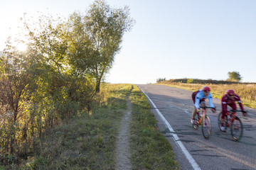 two cyclists move down the hill