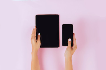 Women hands holding tablet computer and smartphone