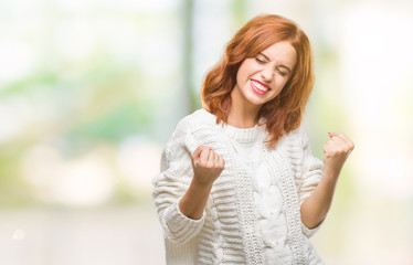 Young beautiful woman over isolated background wearing winter sweater very happy and excited doing winner gesture with arms raised, smiling and screaming for success. Celebration concept.