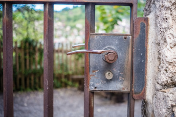 Lock and handle of an old rusty gate near a church in the Swiss city of Thun (Berner Oberland, Switzerland)
