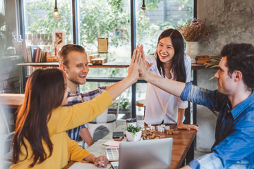 Business diversity people stacking hands for teamwork concept at cafe