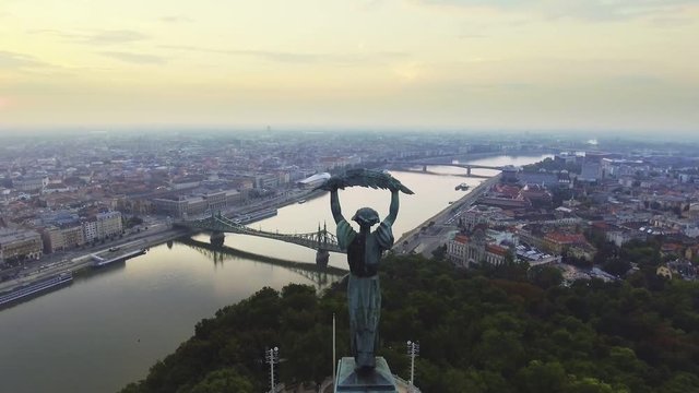 Flying around of Statue of Liberty with the skyline of Budapest at background.