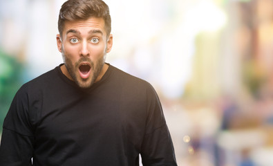 Obraz premium Young handsome man over isolated background afraid and shocked with surprise expression, fear and excited face.