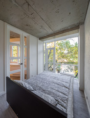 Bed in the apartment. Bedroom in studio apartment. © Aleks Kend