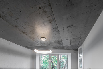 Concrete ceiling and lighting in a modern apartment. Concrete style in the apartment. © Aleks Kend