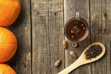 glass cup with tea and wooden spoonful of berry herbal tea