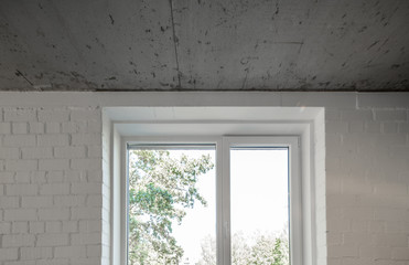 Concrete ceiling and window in a modern apartment. Concrete style in the apartment.