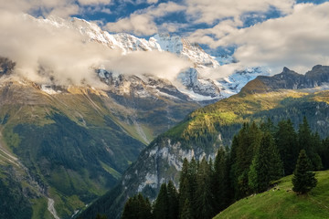 The sun is setting on the gorgeous mountains  near the town of Murren (Berner Oberland, Switzerland). Murren is a traditional mountain village and is unreachable by public road.