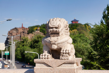 Fototapeta na wymiar Stone lion on Xi Daqiao Bridge Urumqi Xinjiang China
