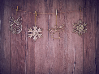 Christmas decorations on a wooden background. New Year decorations and free space for text on a wooden background. Holidays decor on the clothespins. Vintage texture