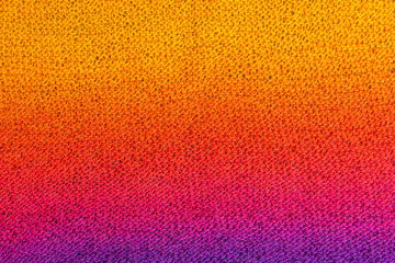 knitted fabric background with garter stitch pattern in pink, purple, yellow and orange