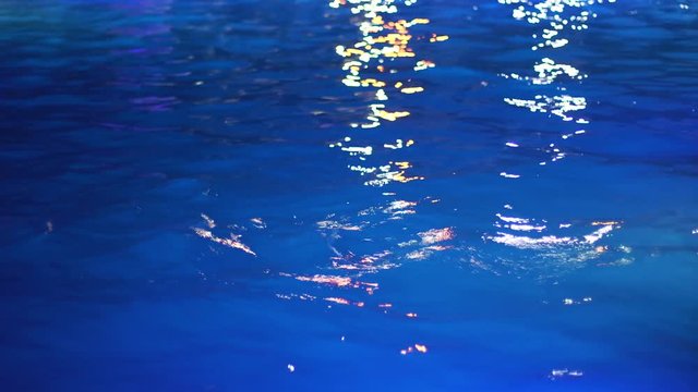 the texture of the blue water in the swimming pool at night