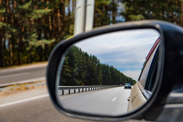 look in the rear view mirror of a car