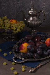 Still life with fresh fruit and antique dishes