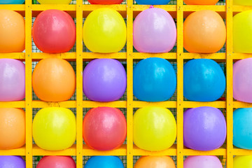 Inflatable balls in square shelves. Multicolored balls background of balls.