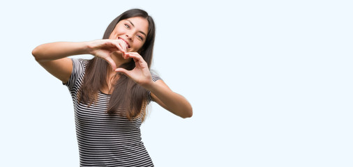 Young beautiful hispanic woman smiling in love showing heart symbol and shape with hands. Romantic concept.