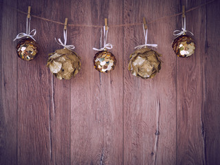 Christmas decorations on a wooden background. New Year decorations and free space for text on a wooden background. Holidays decor on the clothespins. Vintage texture