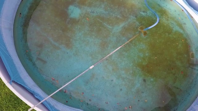 Overhead view of a half empty swimming pool needs to be cleaned