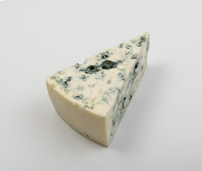 Piece of Blue Cheese on White Background Close Up