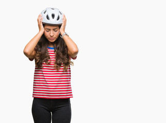 Young arab cyclist woman wearing safety helmet over isolated background suffering from headache desperate and stressed because pain and migraine. Hands on head.