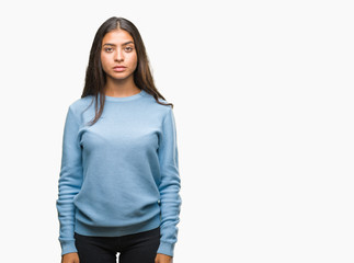 Young beautiful arab woman over isolated background with serious expression on face. Simple and natural looking at the camera.