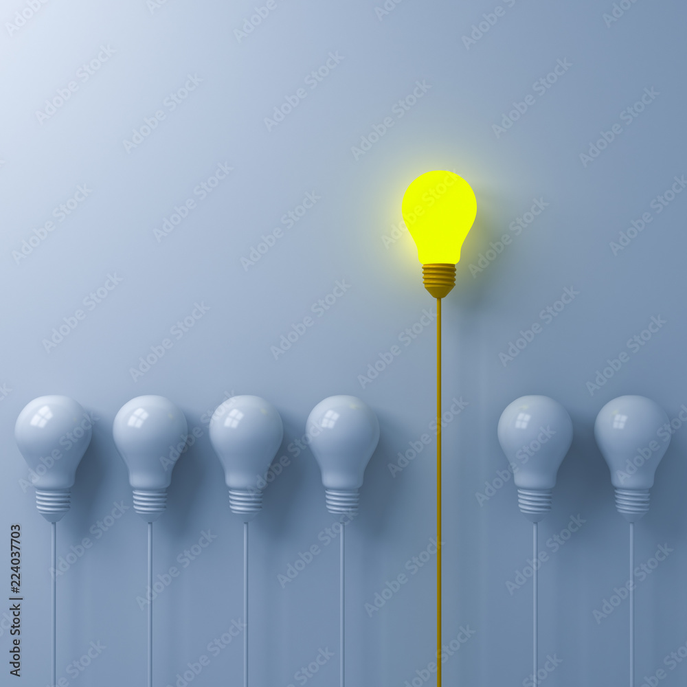 Leinwandbilder think different concept one glowing light bulb standing out from the dim or unlit white lightbulbs o